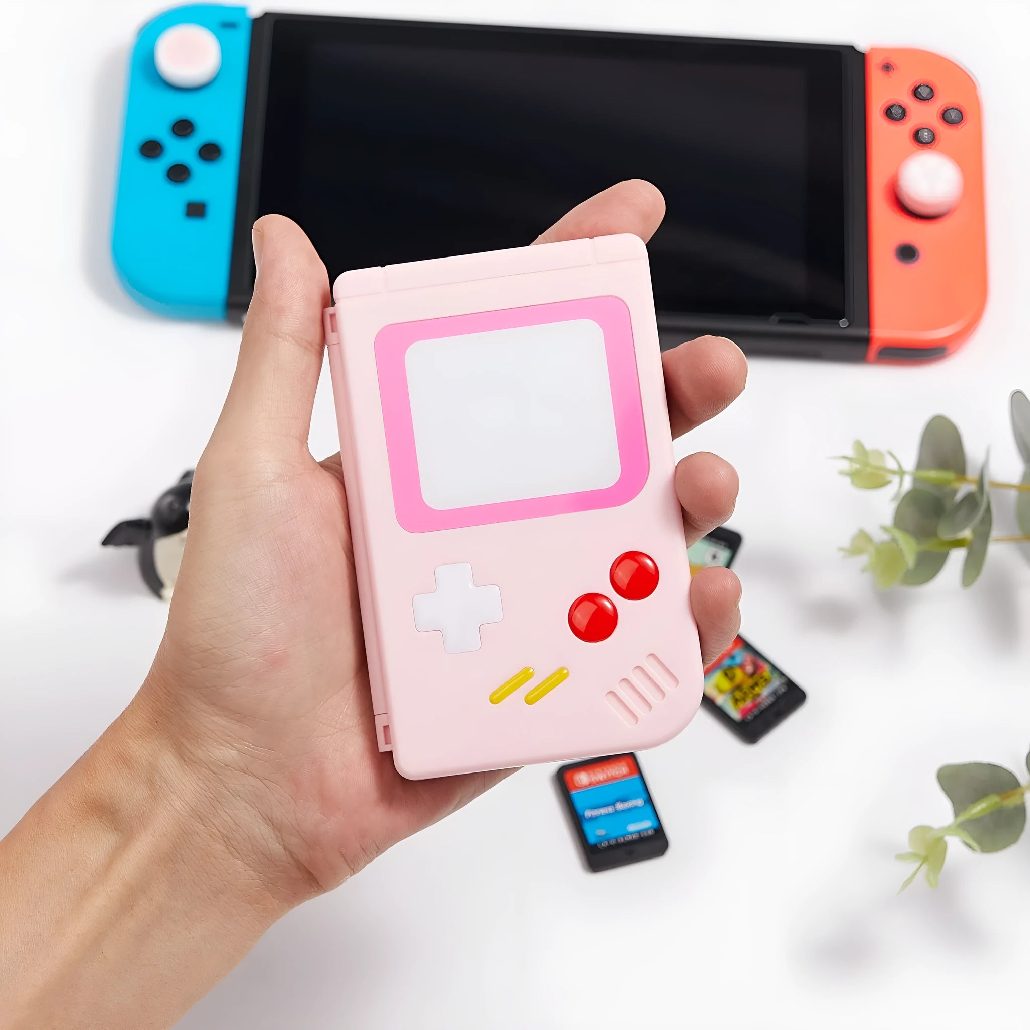 Compact blue Nintendo Switch game card storage box shown next to game cards.