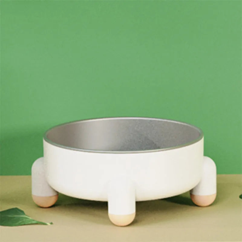 Green high-footed non-slip stainless steel bowl for dogs and cats on a floor.