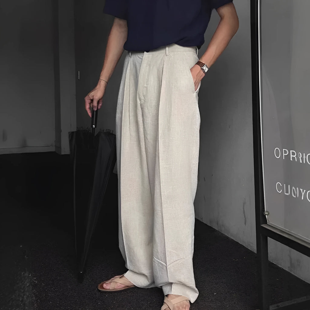 Men's loose-fit apricot cotton linen trousers with wide-leg Korean style on a neutral background.