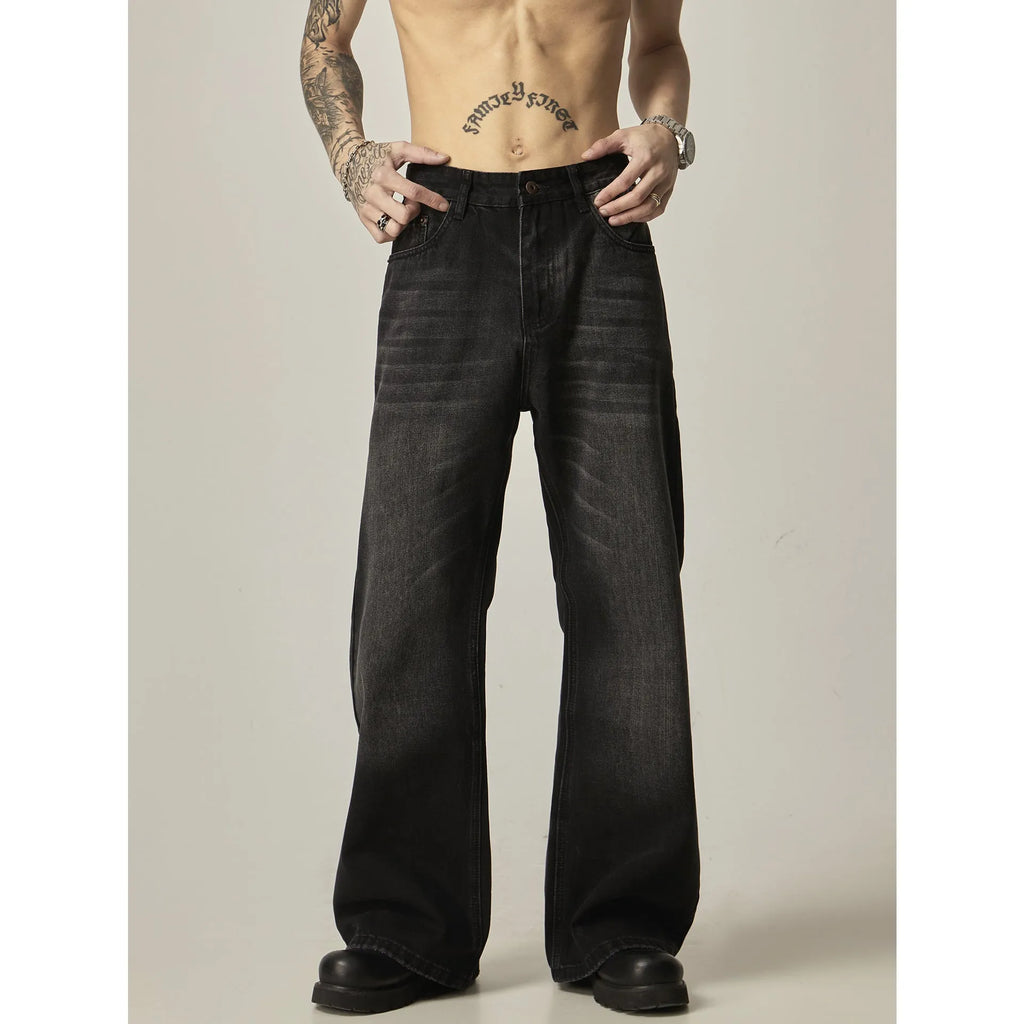 Black loose straight leg retro jeans on a hanger showing zipper fly detail
