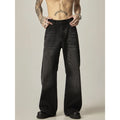 Black loose straight leg retro jeans on a hanger showing zipper fly detail