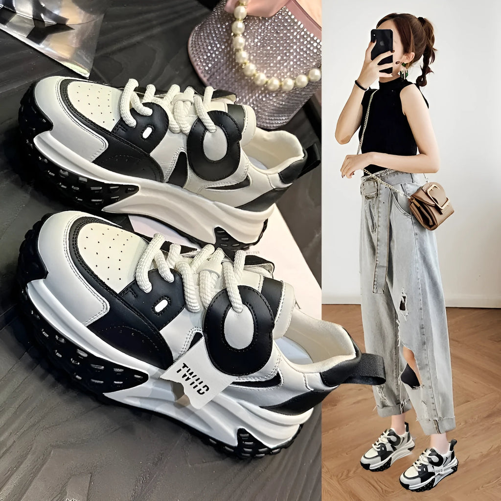 A pair of leather casual shoes with a thick wedge sole, round toe, and front lace-up design.