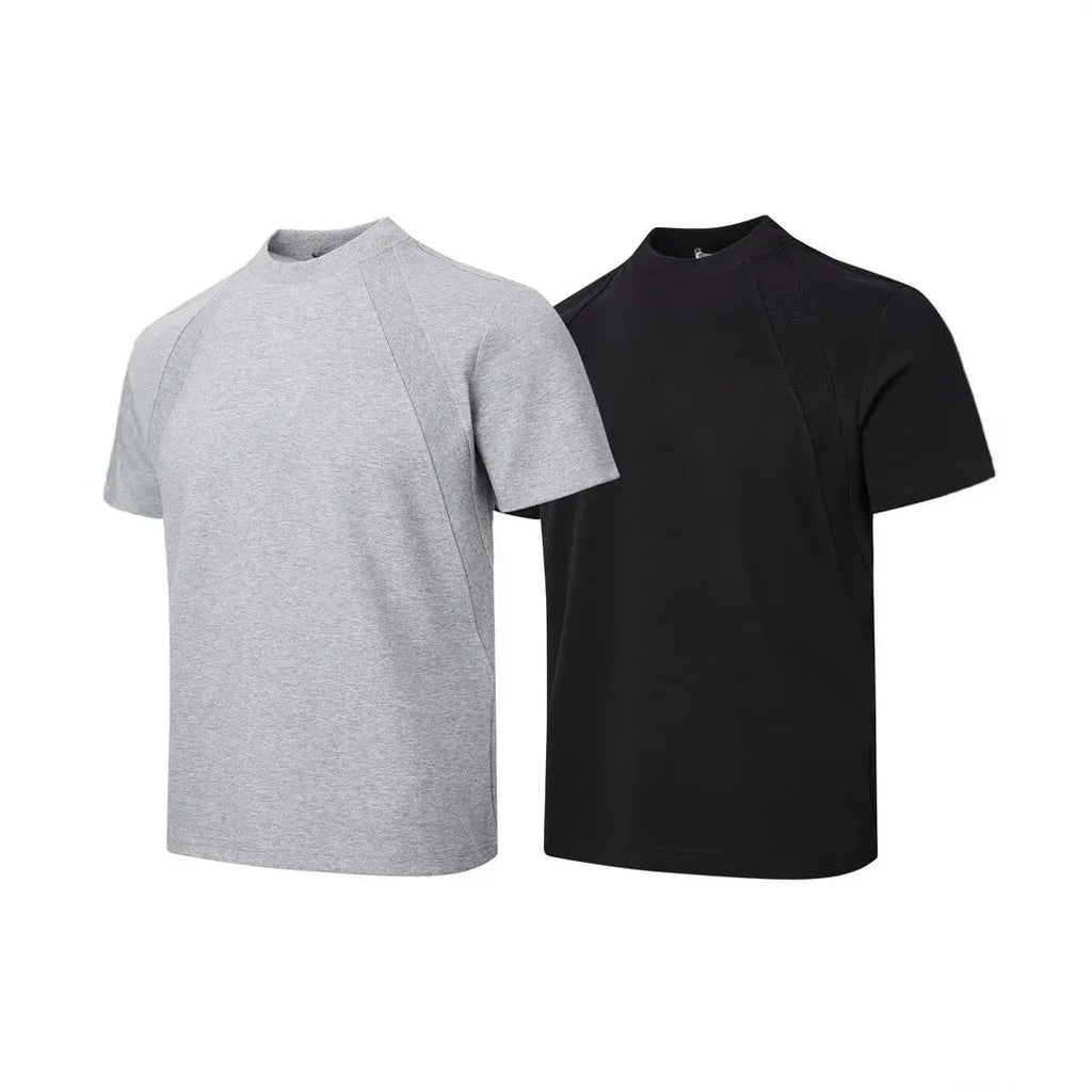 Man wearing a loose fit black short sleeve top with visible air layer stitching detail.