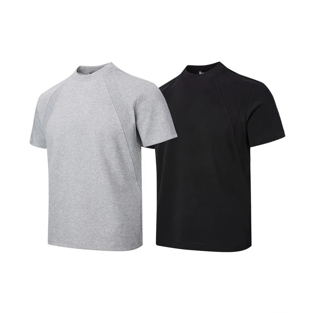 Man wearing a loose fit black short sleeve top with visible air layer stitching detail.