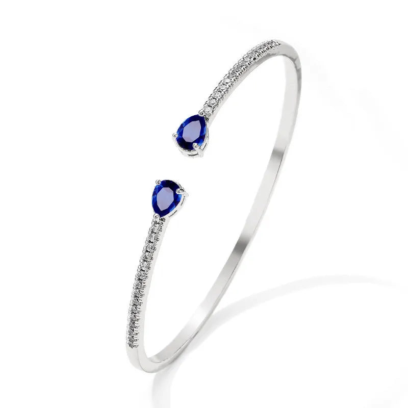 Copper bracelet with inlaid zircon stones in a simple design, shown in white and blue colour options.