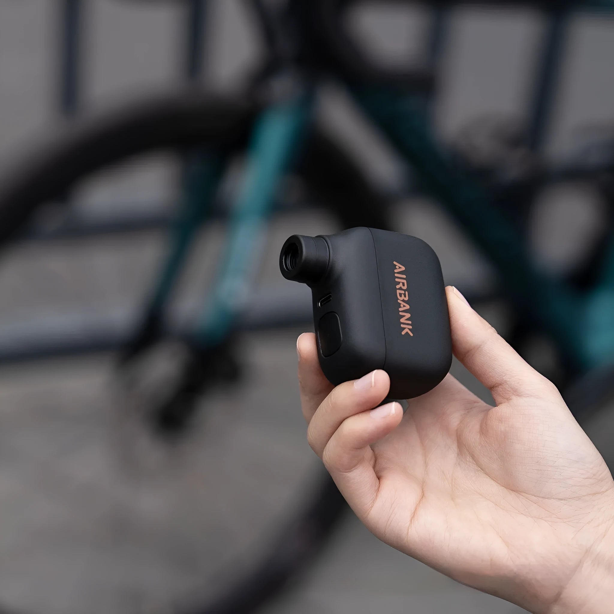 Black mini electric bicycle pump with USB charging cable and waterproof storage bag