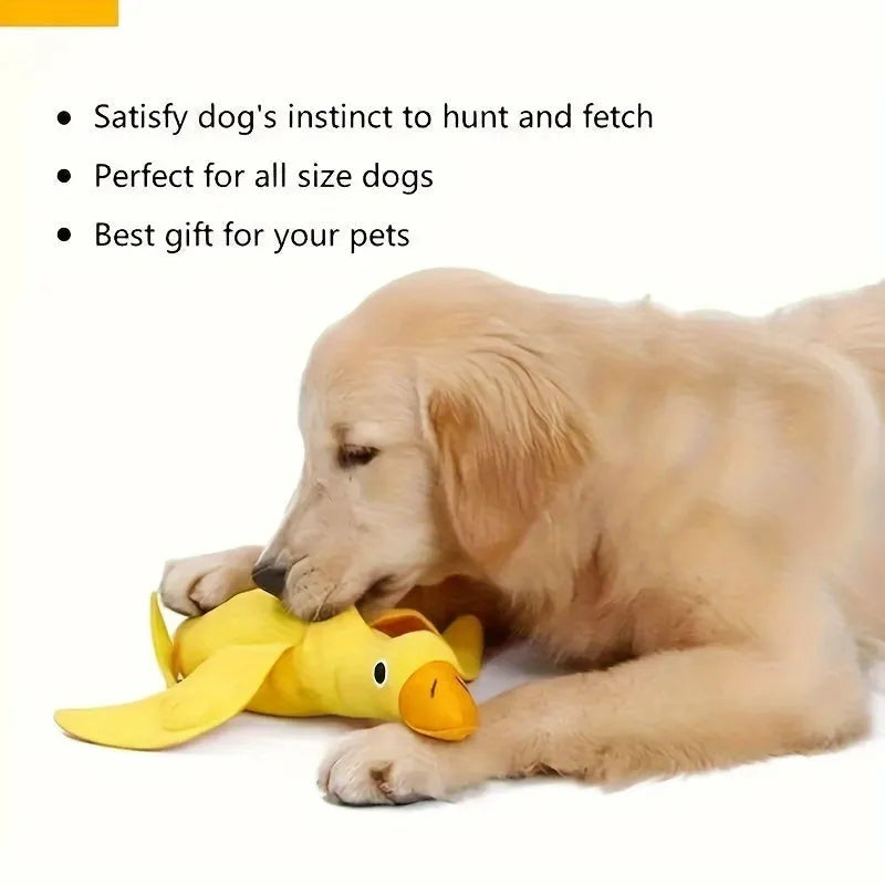 Yellow plush duck dog toy with squeaker and treat-dispensing feature for training and play.