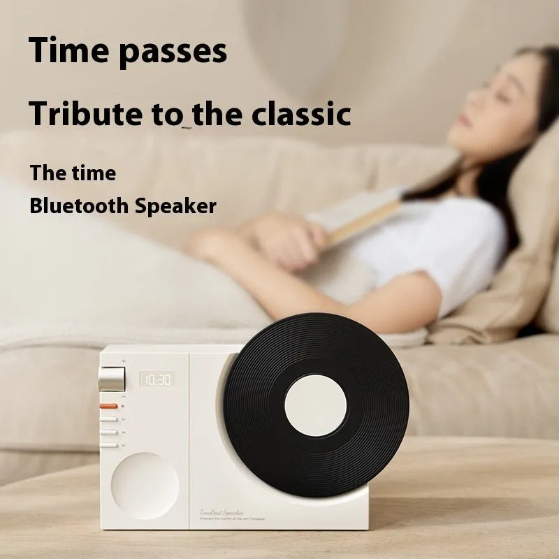 Mini portable Bluetooth speaker in Obsidian Black colour with a card slot, shown with USB cable.