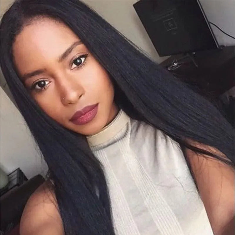 Long straight black synthetic wig with centre-parted bangs on a hair cover.