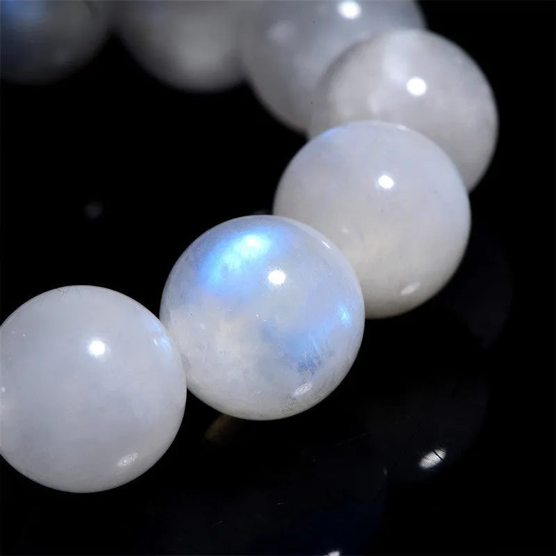 Natural blue moonlight round bead moonstone bracelet showing polished gemstone beads on wrist