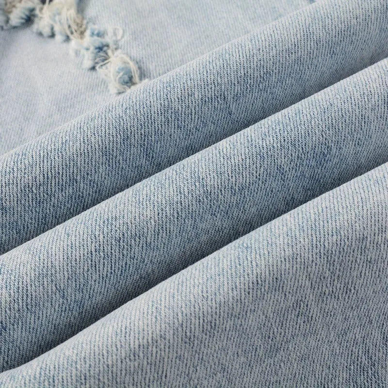 Light blue men's elastic slim fit jeans with hot diamond patch and whisker scrape detailing