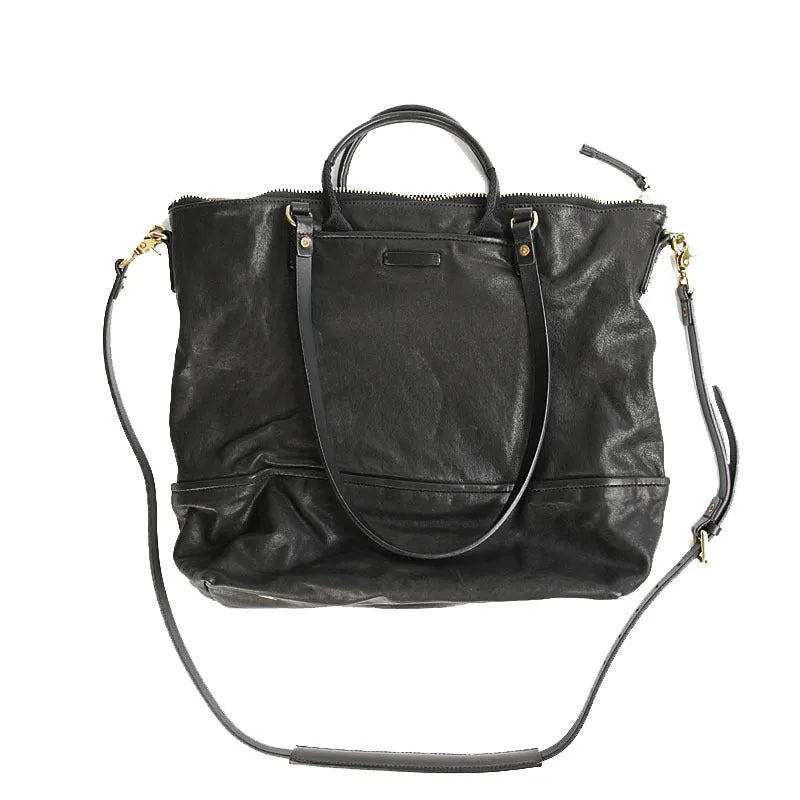 Black handmade vegetable tanned cowhide tote bag with zipper closure and large capacity for travel