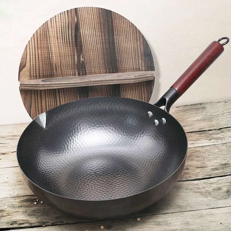 Traditional black iron wok with wooden handle measuring 32cm