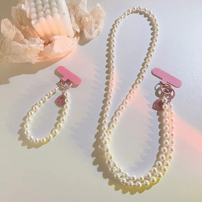 Pink pearl bead mobile phone lanyard with crossbody shoelace and wrist strap on white background