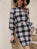 Black tight dress with voluminous lantern sleeves, leather stitching detail, and a printed pattern, mid-length skirt.