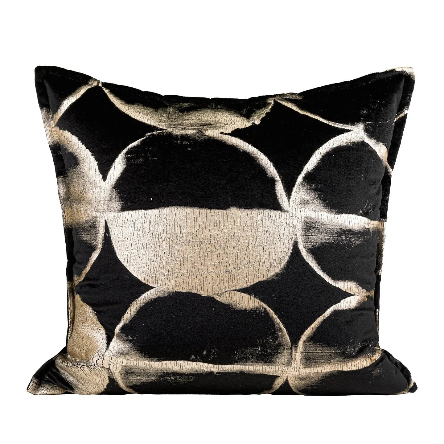 Black and gold abstract pattern decorative cushion cover on a grey sofa.
