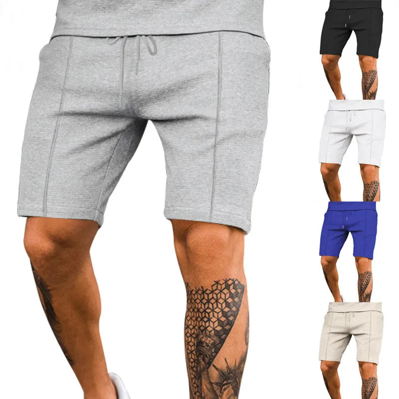 Solid colour polyester five-point sports shorts in Khaki, side view, showing elastic waist and above-knee length
