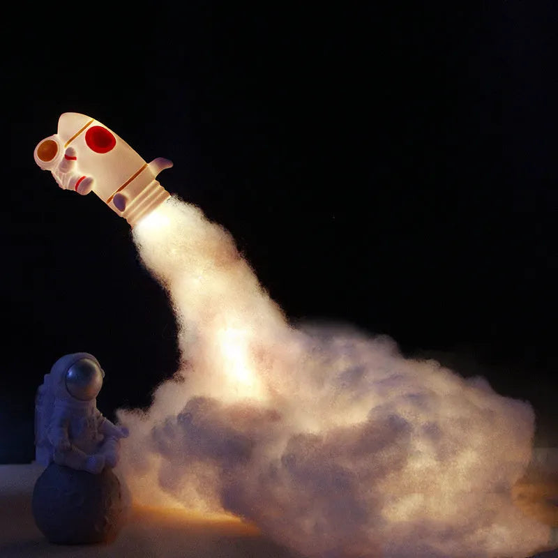 DIY astronaut rocket night light kit with warm LED string lights, plastic chassis, and straws for assembly.