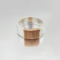 Simple geometric ring bracelet in electroplated copper with silver gold coil finish showing irregular coil design
