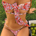 Women's lace-up front swimsuit with floral pattern and integrated chest pad