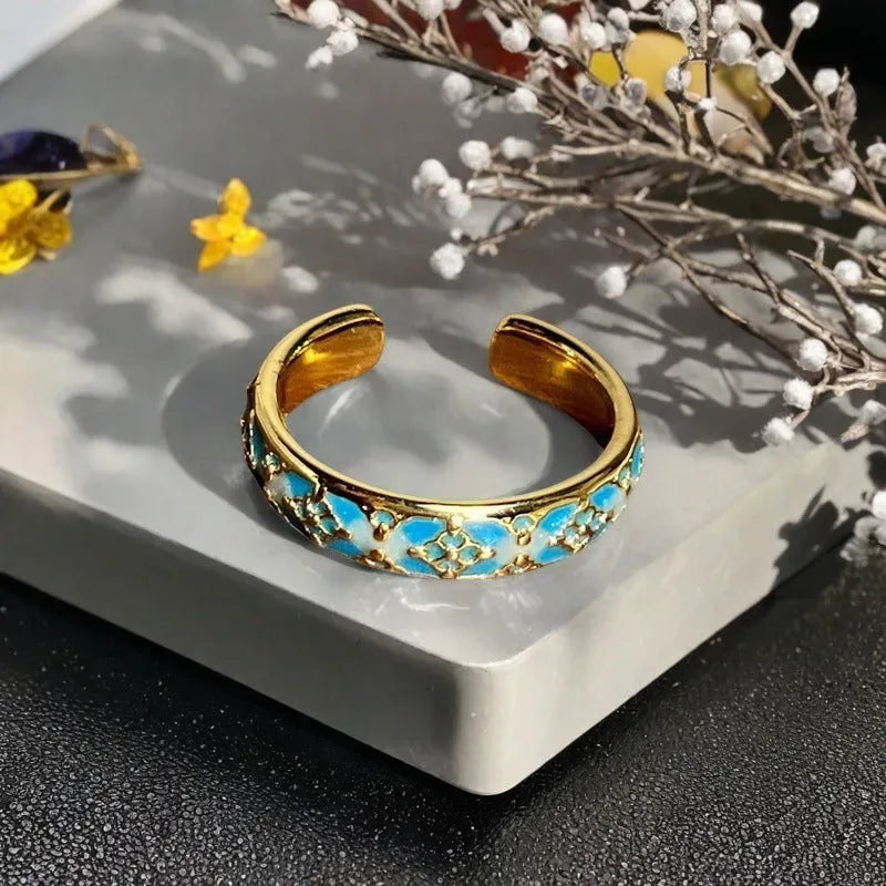 Adjustable vintage-style copper ring with gourd, flower, and bow design featuring inlaid zircon stones.