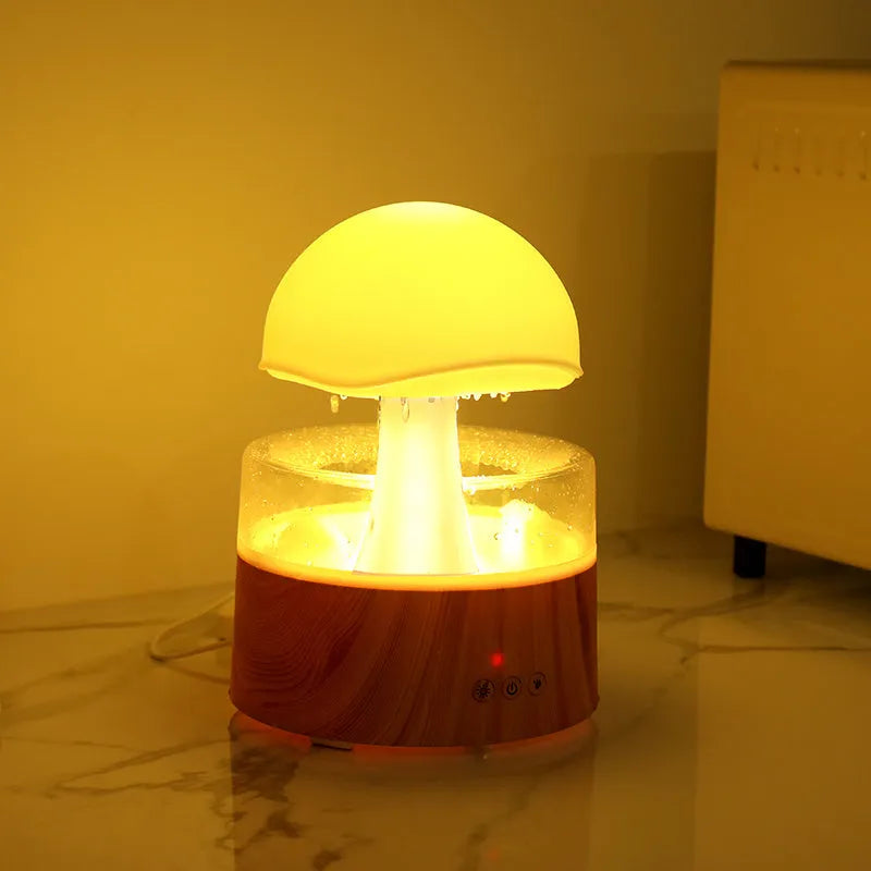 White rain cloud-shaped humidifier and essential oil diffuser on a surface