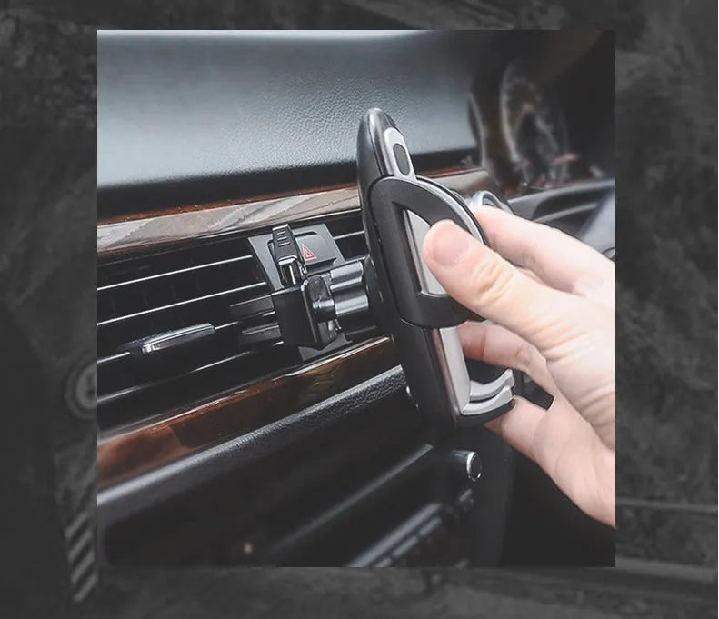 Black universal car mobile phone holder mounted on air conditioning outlet with smartphone secured
