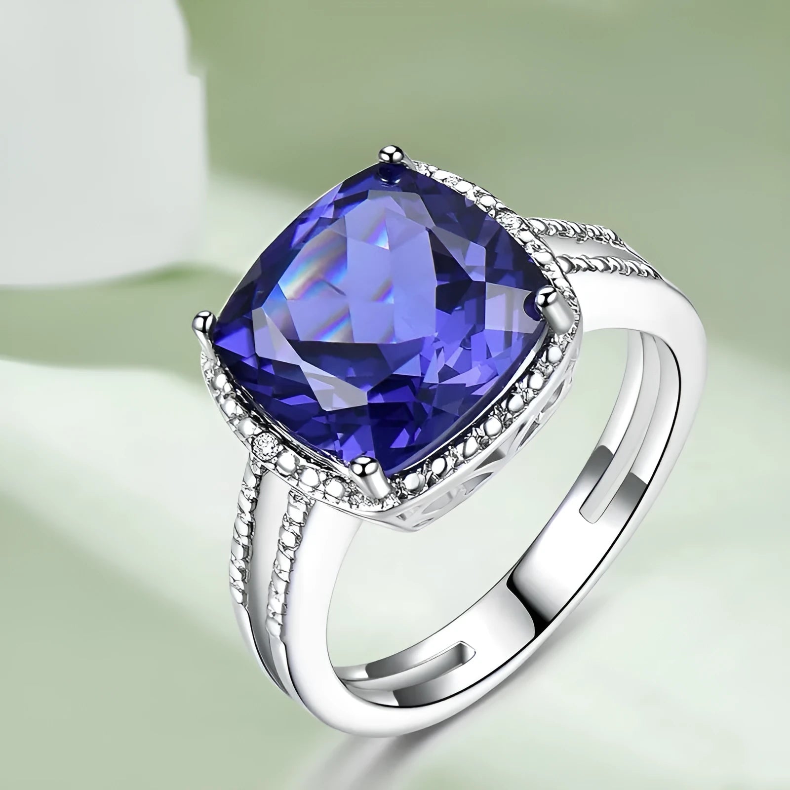 Women's 925 Sterling Silver ring with a blue Tanzanite stone, shown on a finger.