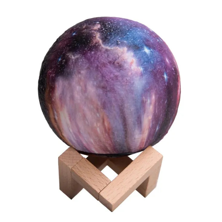 3D printed spherical moon lamp glowing on a surface, showing its textured lunar surface and soft LED light.
