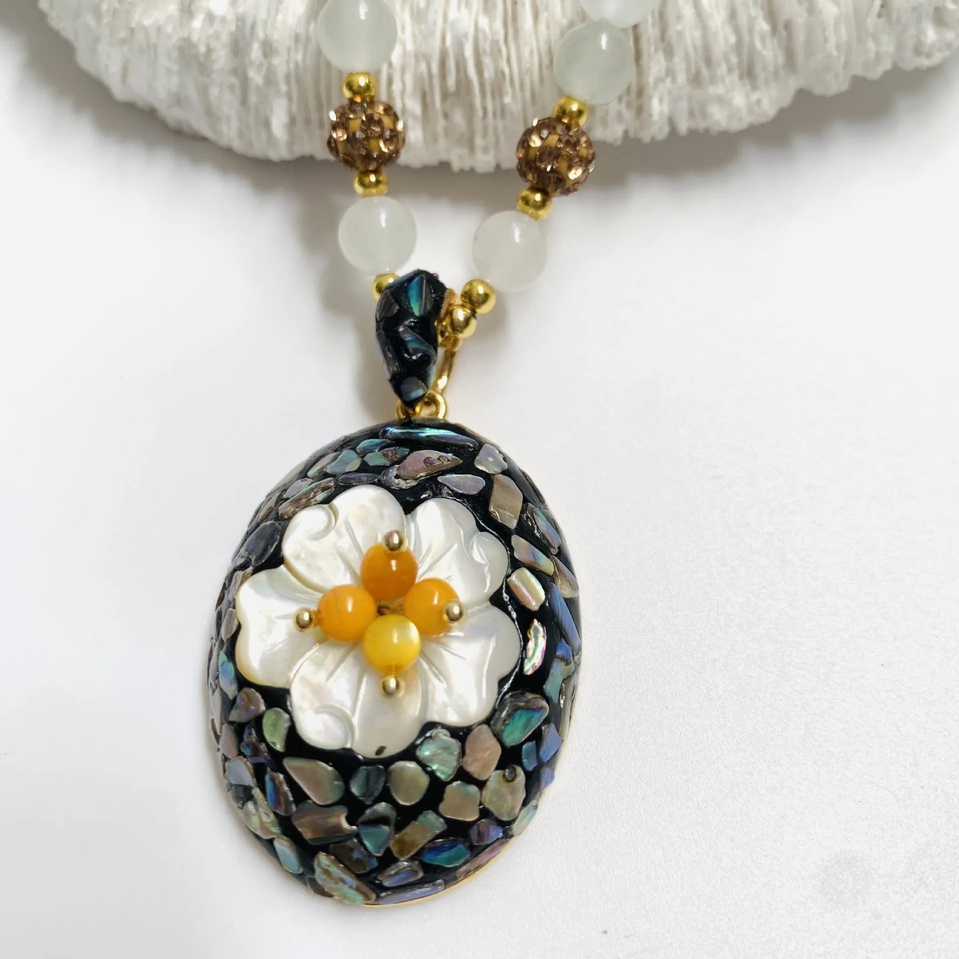 Original design mother-of-pearl shell necklace with rhinestone accents and twist chain