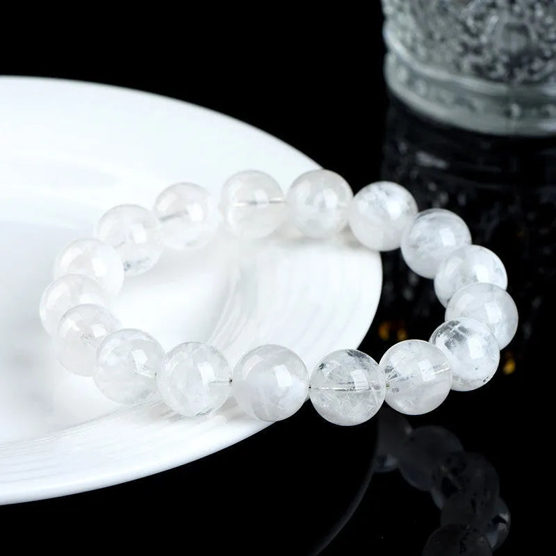 Close-up of a women's bracelet with round geometric crystal beads in a natural blizzard snowflake finish, showing Ruyi and Xiangyun design details.
