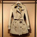 Khaki women's trench coat with double-breasted button front and structured flight sleeves