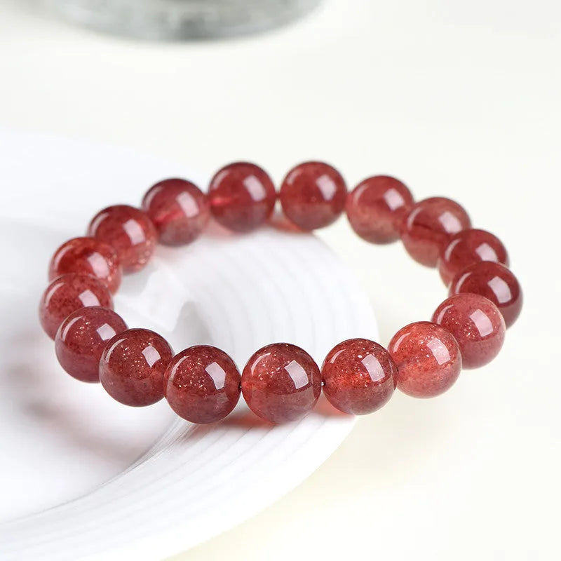 Natural strawberry quartz crystal bracelet with geometric beads showing starry inclusions