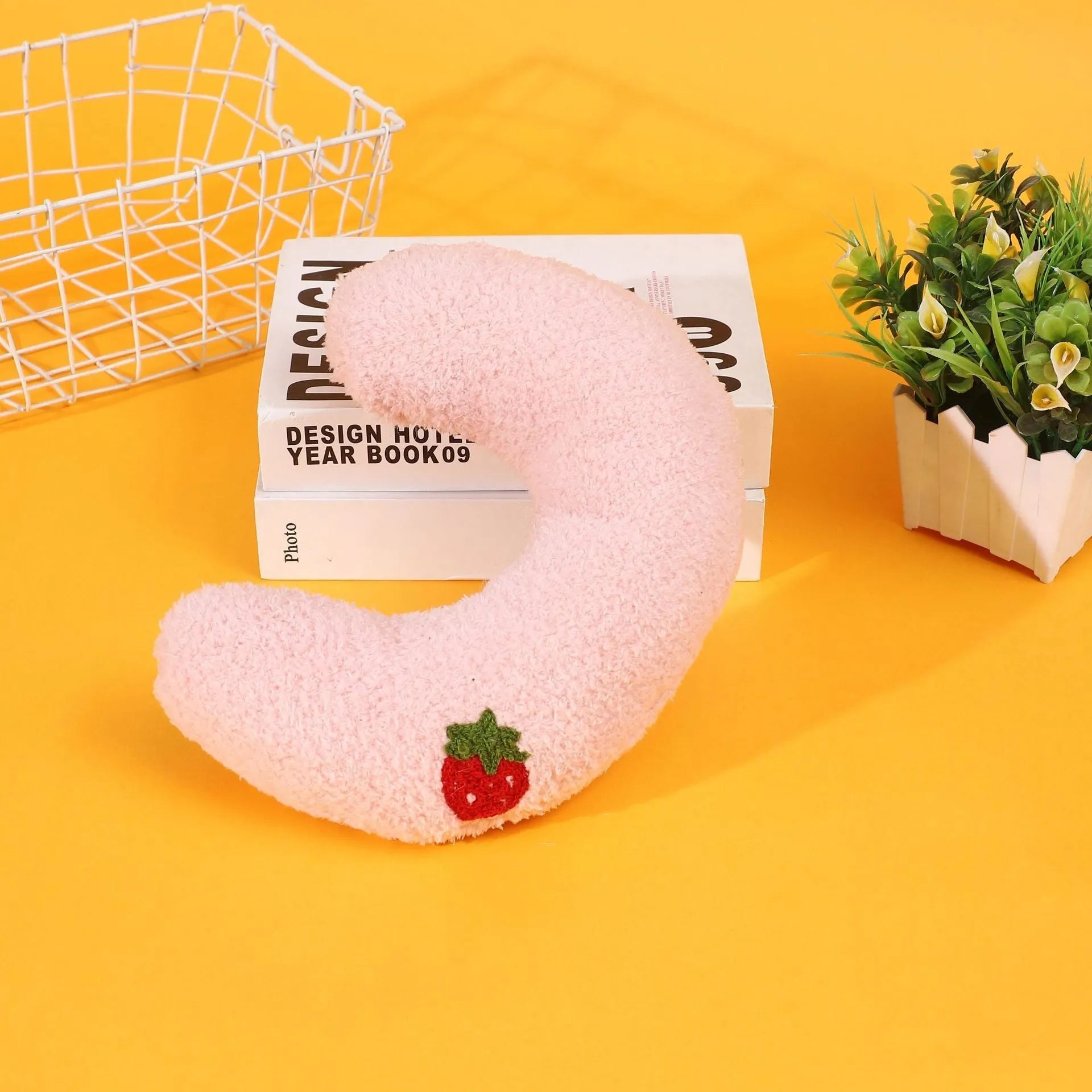 Half moon U-shaped cloth pillow for cats in blue, pink, white, and yellow colour options.