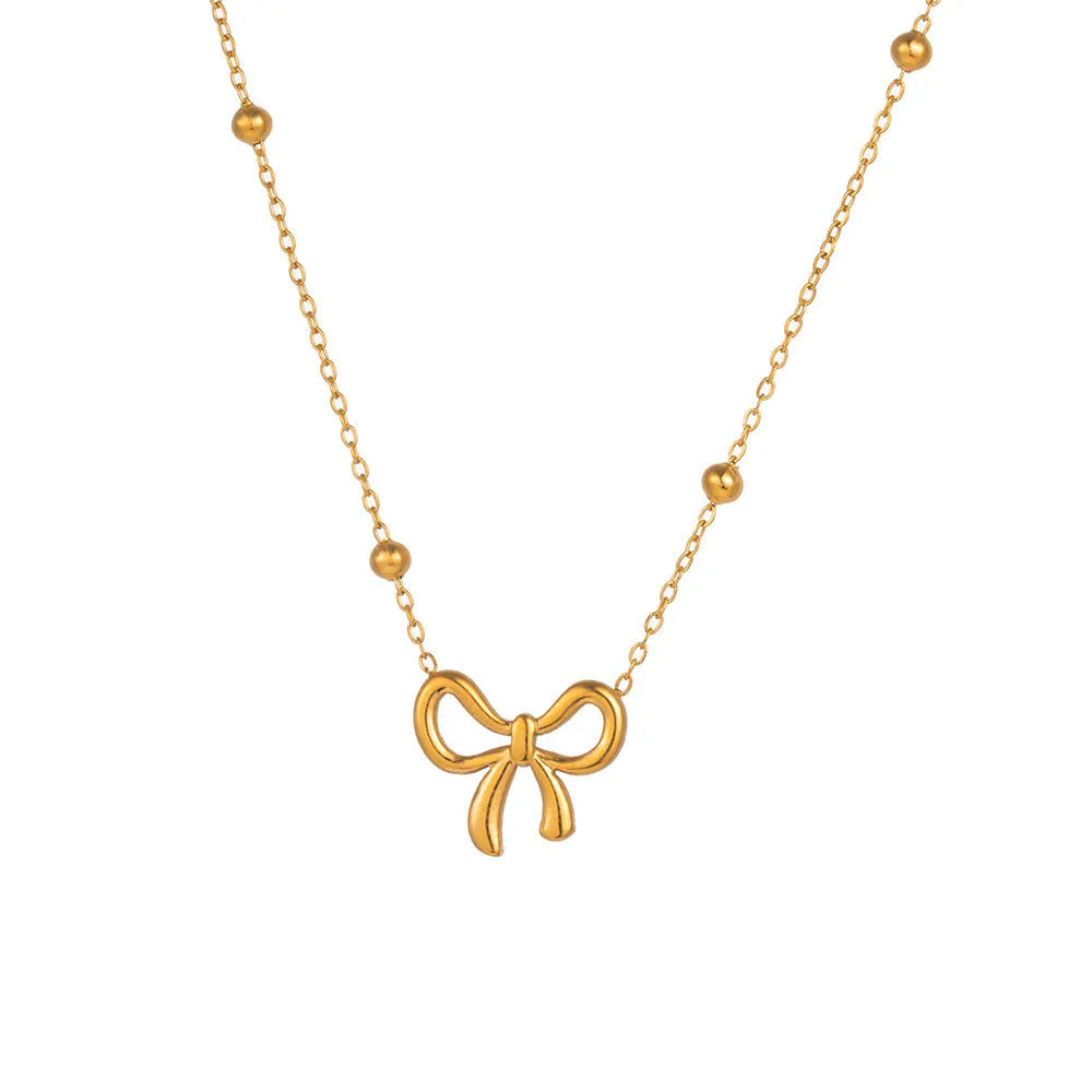 Gold-coloured titanium steel necklace with bow design and cross chain construction