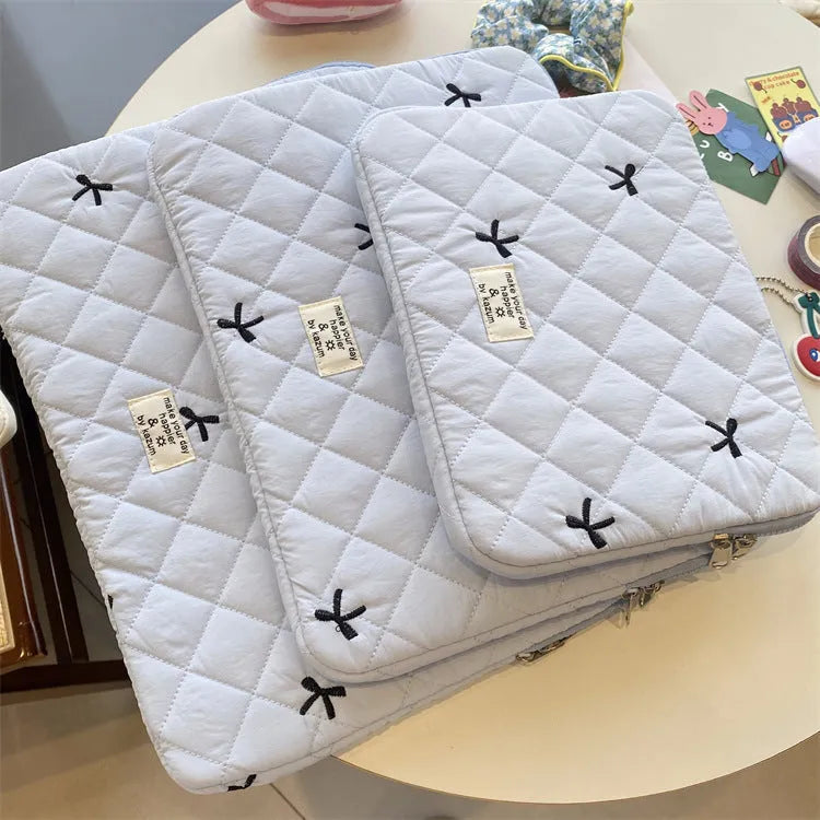 Rhombus embroidered bow design on nylon laptop storage bag showing colour and size options