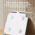 White professional body fat scale with 8 electrodes on tempered glass platform