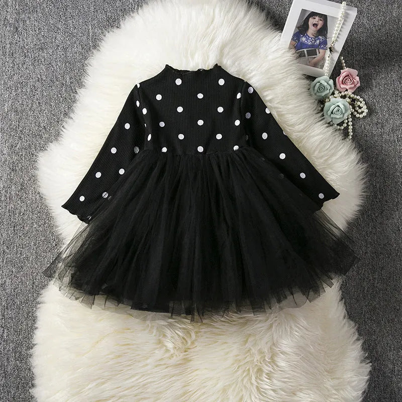 A baby girl's long sleeve black tutu dress with lace detail, suitable for birthdays and christenings.