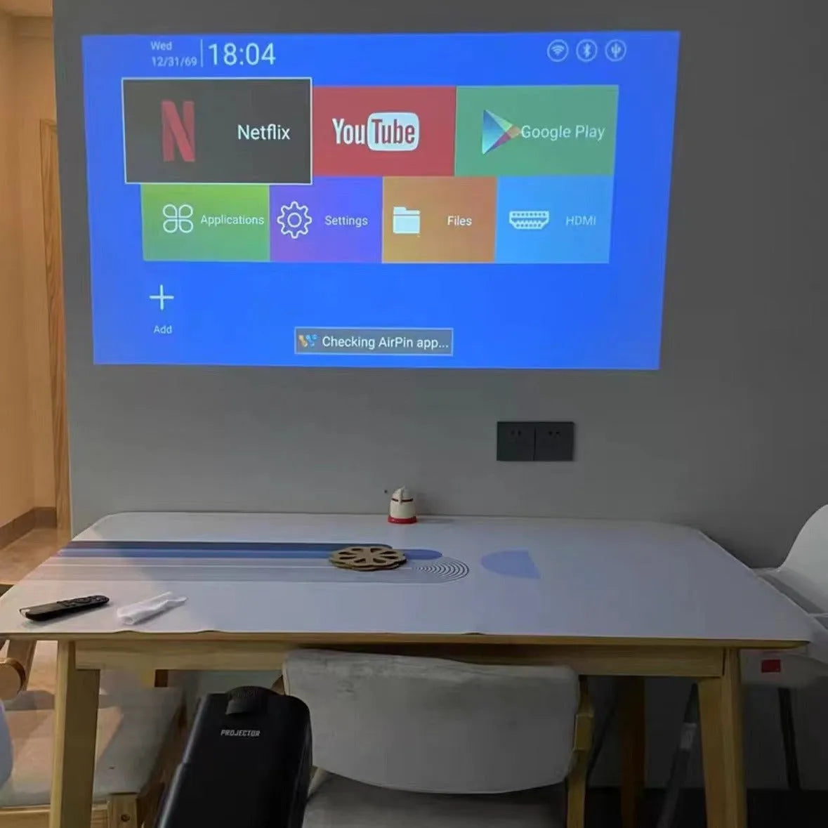 Wireless game machine projector with 720p HD resolution showing international power compatibility symbols