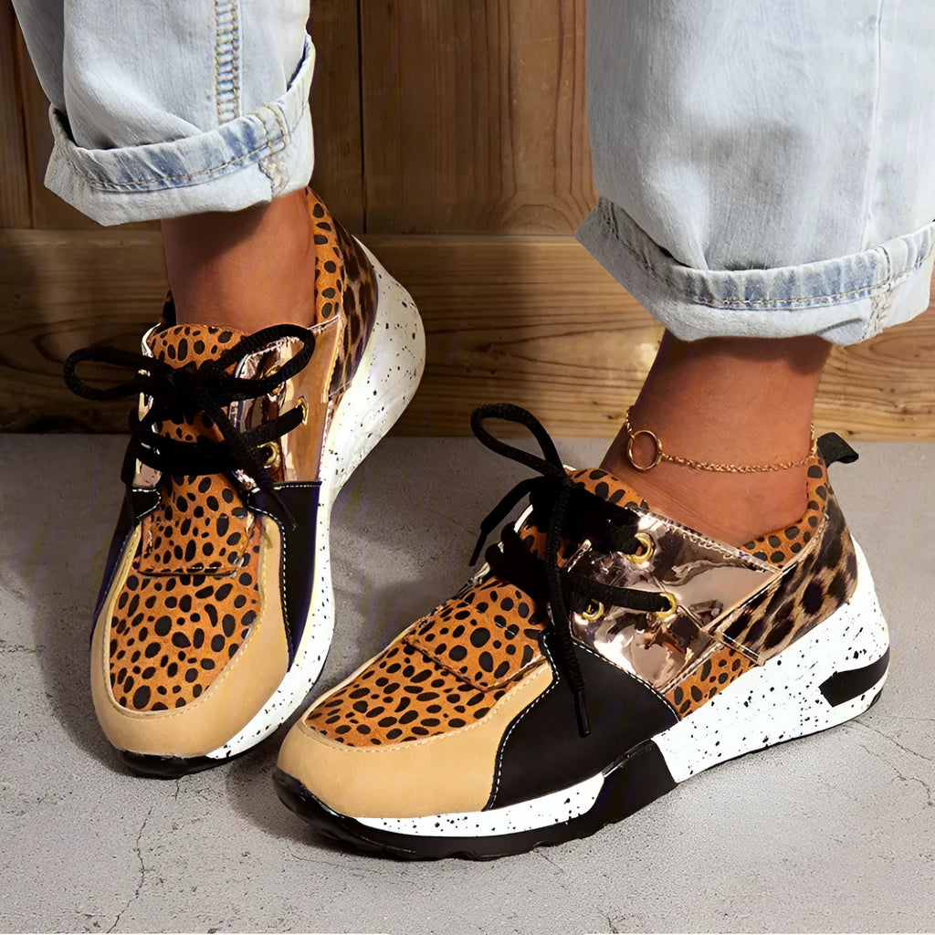 Women's black suede casual sneakers with a wedge heel and round toe on a white background.