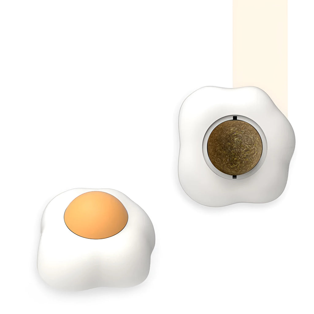 Interactive catnip ball toy stuck to wall with cat playing, showing fried egg and poached egg shape options
