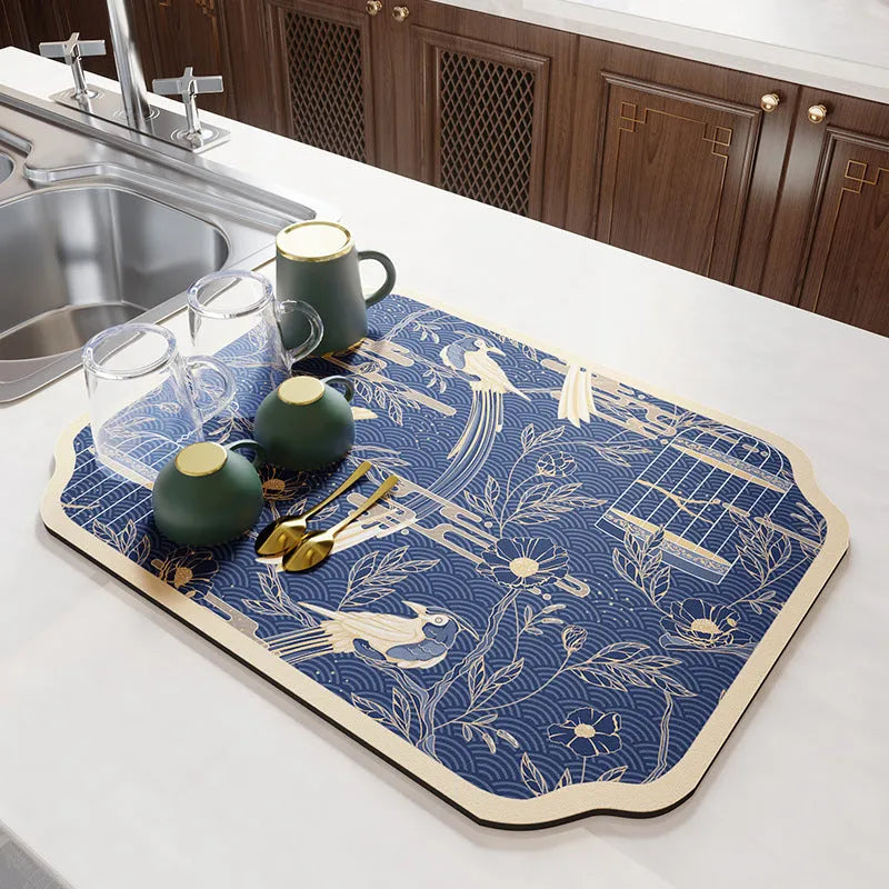 Square diatomite kitchen draining mat in camellia purple on a kitchen worktop, with a teacup resting on it