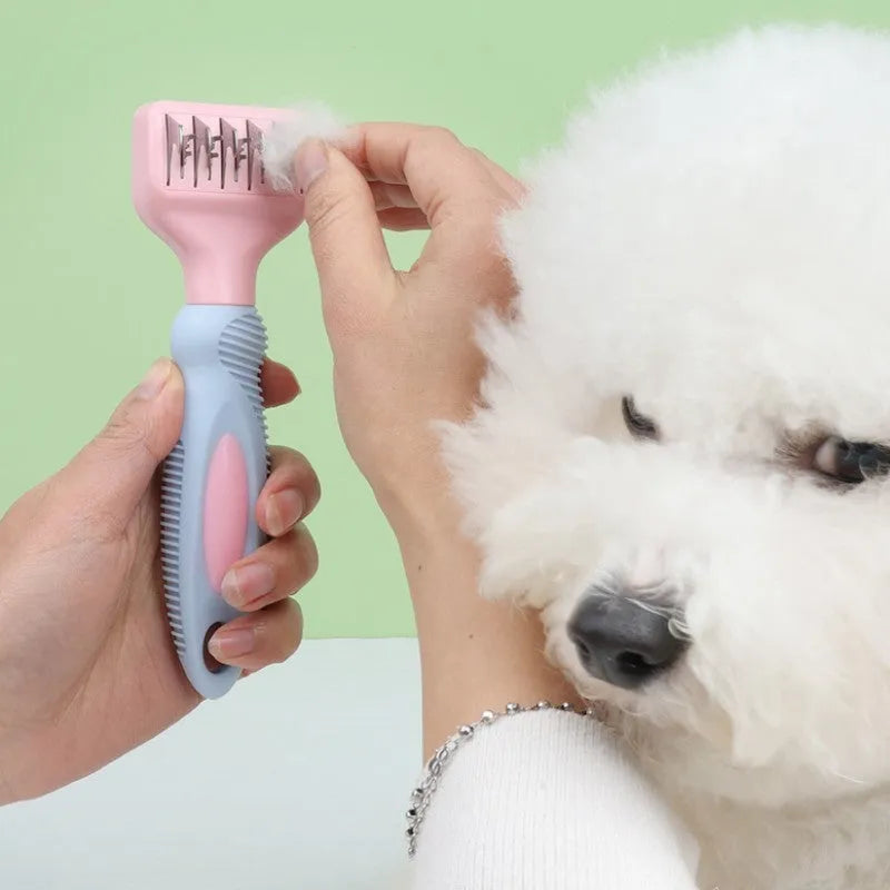 Stainless steel dog comb with knot knife edge and massage nodules, shown in pink colour option