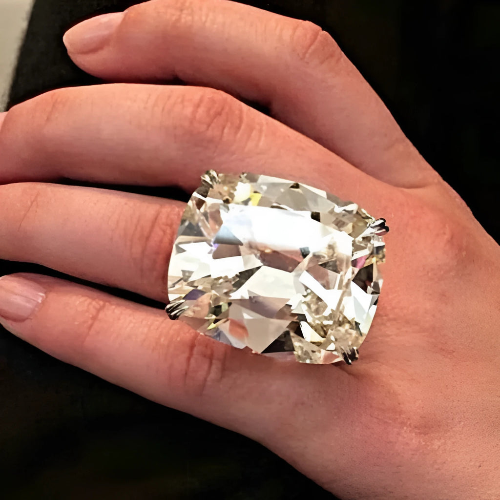 Women's simple white gold colour alloy ring with a square diamond inlay, shown on a finger.