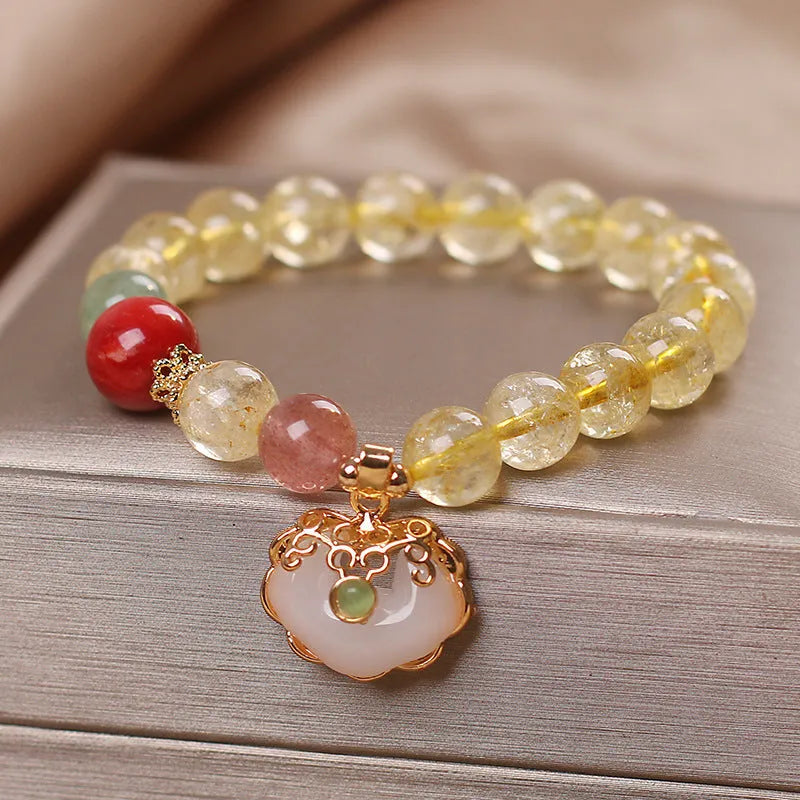 Women's bracelet with a citrine jade ruyi pendant and yellow hair crystal on an alloy band.