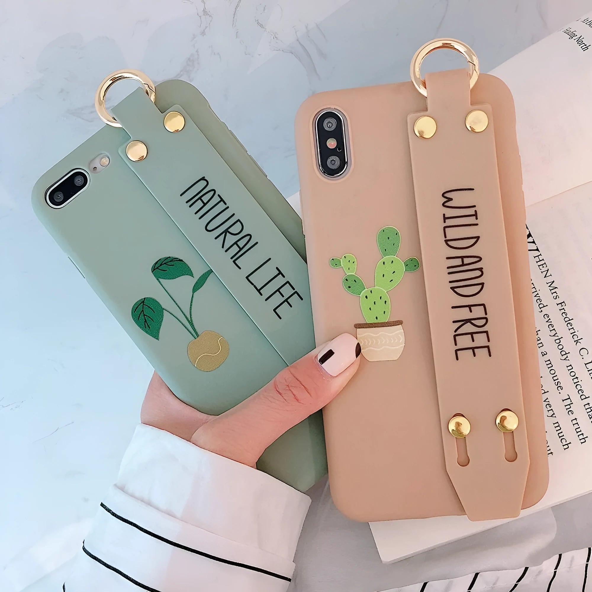 Green graffiti design iPhone case with a black detachable wrist strap looped around a hand.