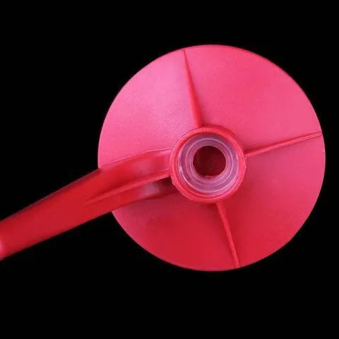 Red plastic Magic Tap soda dispenser screwed onto a 2-litre bottle with push-in tap