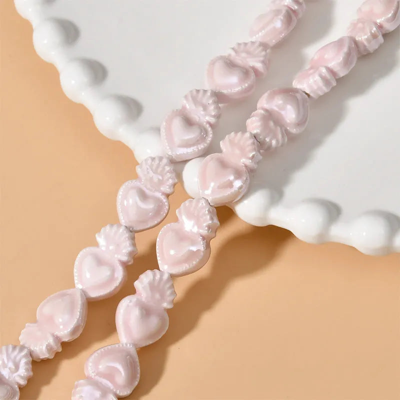 Assorted small ceramic torch beads in multiple colours on a white background.