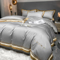 All-cotton light luxury four-piece bedding set with embroidery, available in multiple colours, on a bed