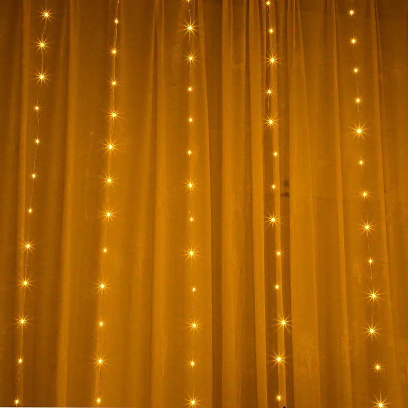 Copper curtain string light with 100 LED bulbs in blue, hung decoratively against a dark background.